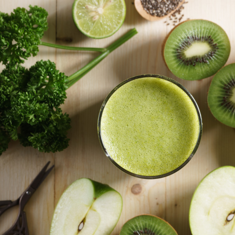 healthy drink surrounded by fruits and vegetables