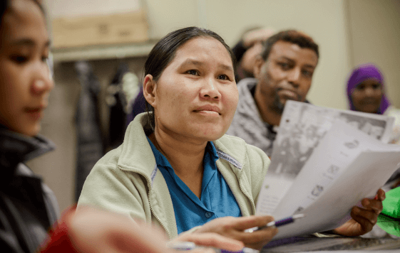 woman actively listening while holding some note papers