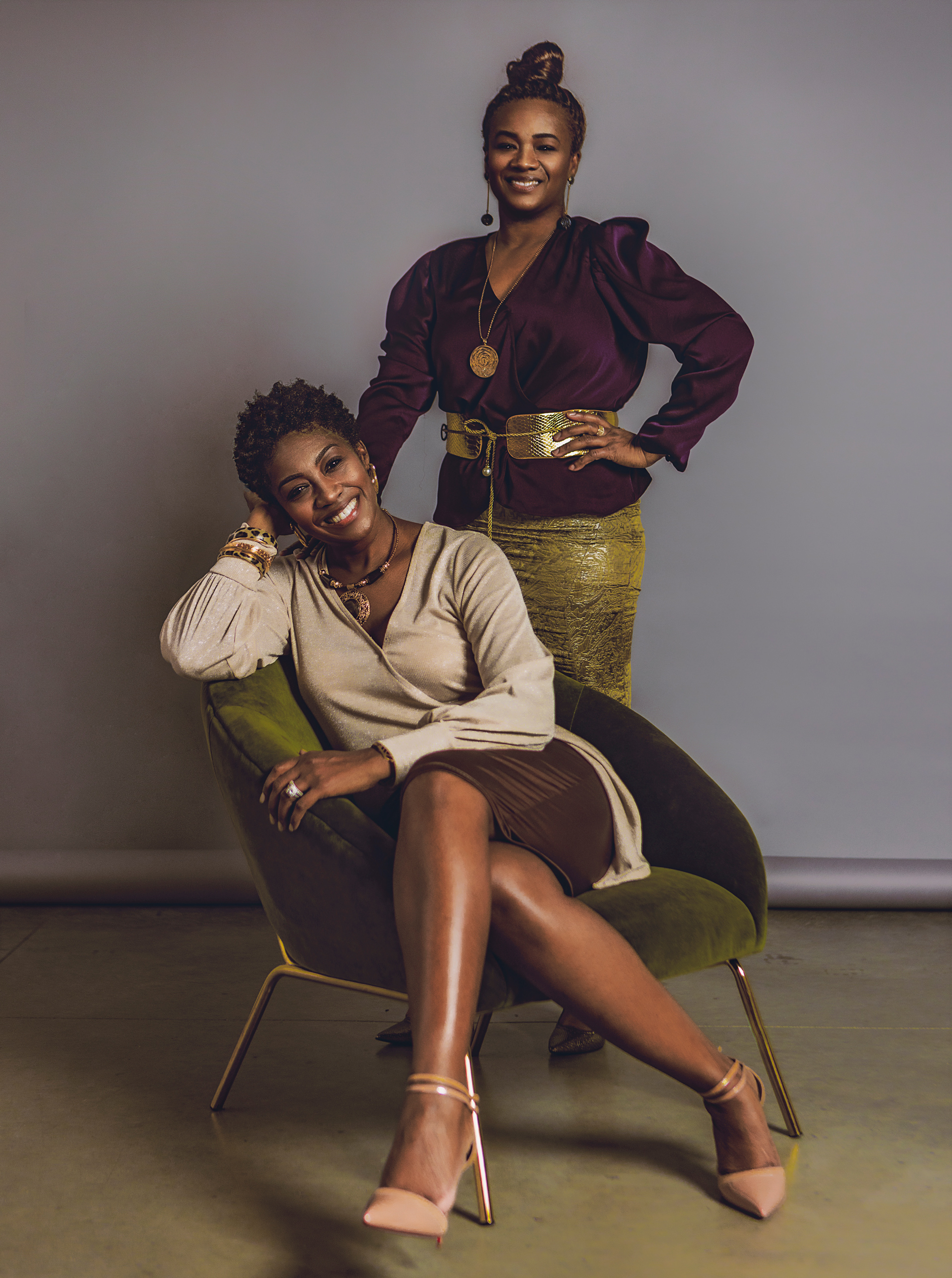 two women posing for their photo being taken